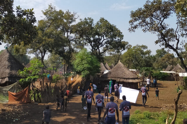 Advocates from Gambella walk around a town.