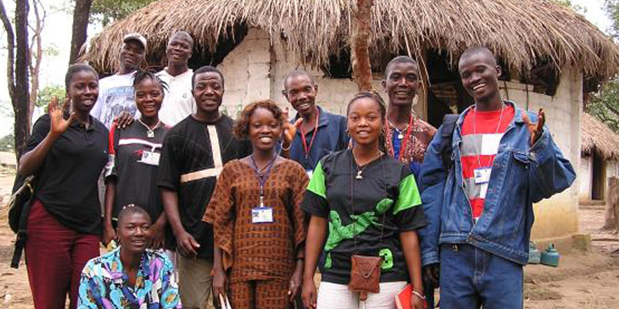 A group of people stand together for a group photo.