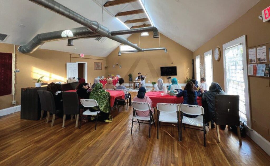 Photo of empty event space, showing chairs and decorated tables and