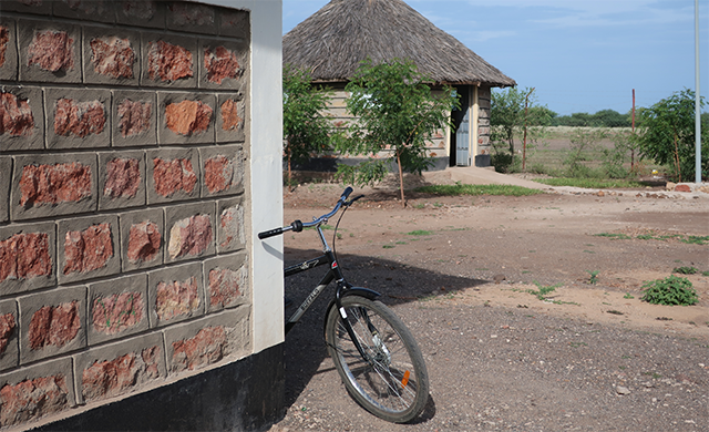 A bike leans against a building.