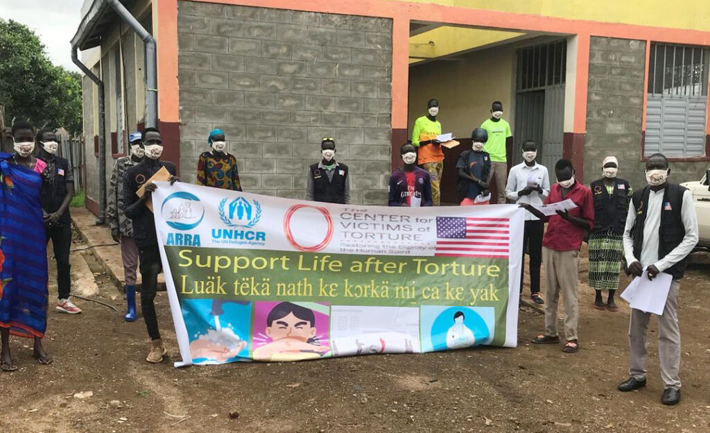 CVT Ethiopia Gambella staff hold "Support life after torture" banner.