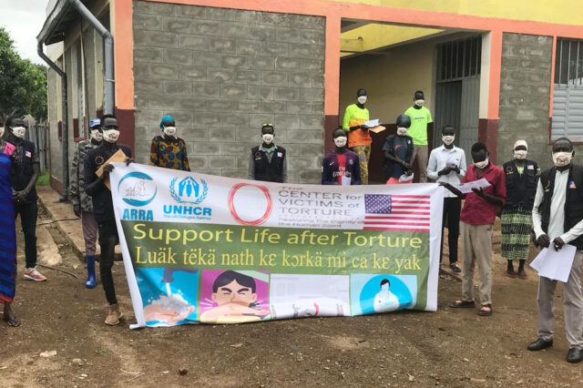 CVT Ethiopia Gambella staff hold "Support life after torture" banner.